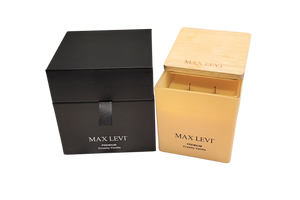 Max Levi Premium Creamy Vanilla Candle outside box beside gift box with lid half open.